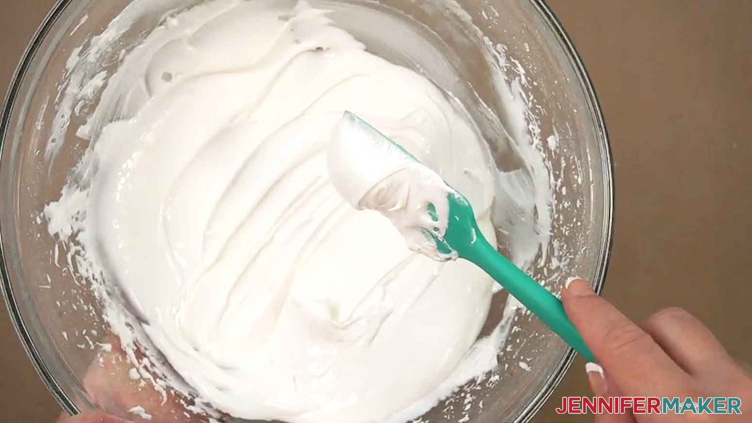 The royal icing has been mixed to the outline consistency with soft peaks of icing dripping off the spatula.