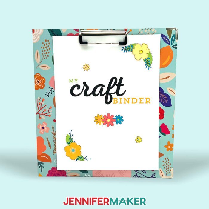 A printed paper with colorful flowers that says "My Craft Binder" clipped to a clipboard.