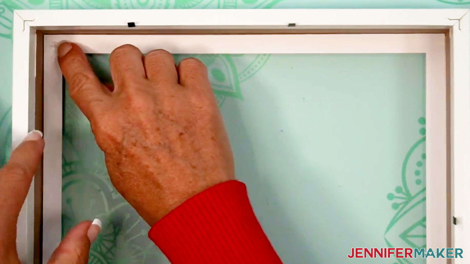 After placing the first layer in the shadow box, apply glue dots to the back side.