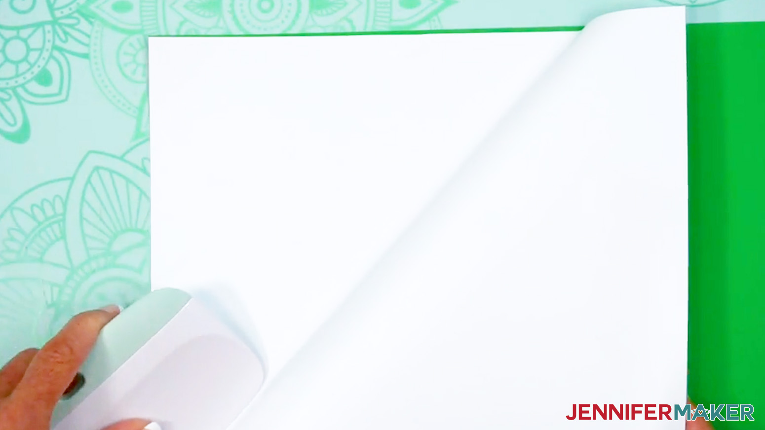 Use a large scraper to adhere the vinyl to the cardstock.