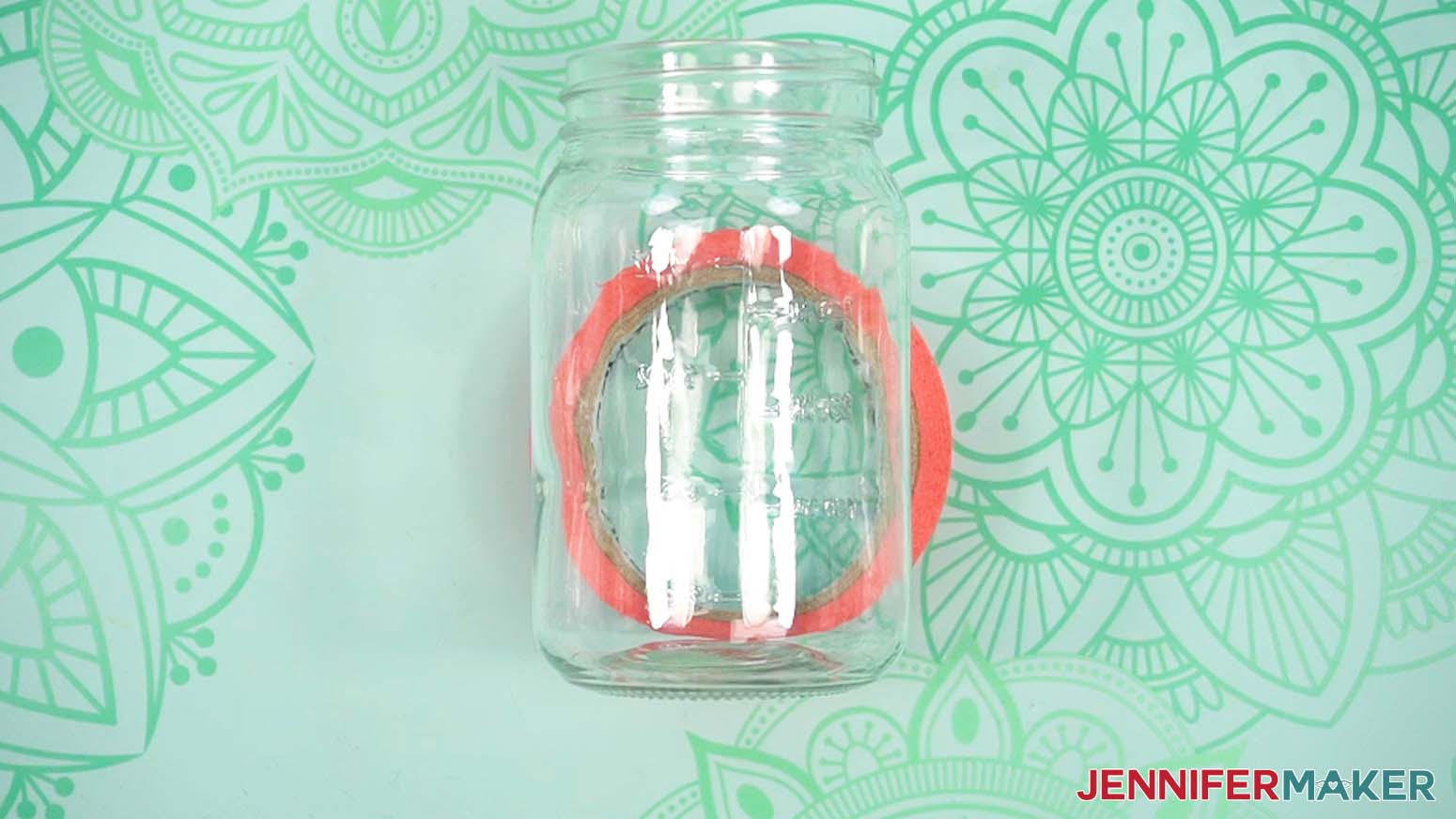 Place a glass mason jar on a roll of painter's tape to help stabilize it while placing the label.