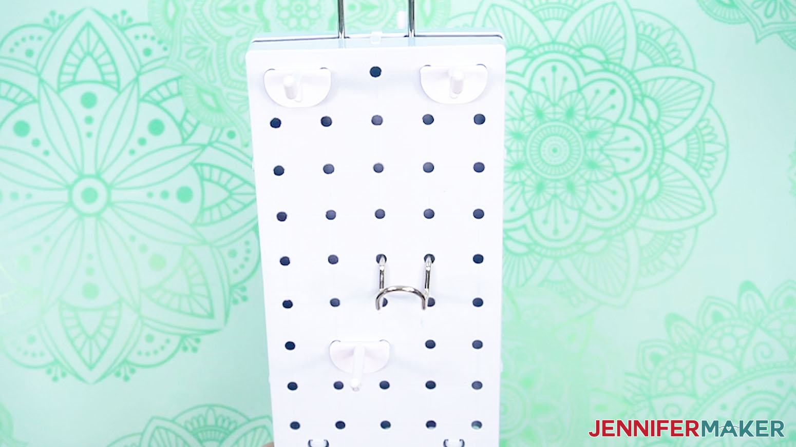 Insert hooks into the pegboard slots.