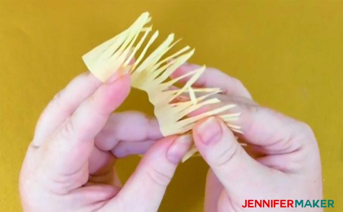 Twist the lengths of crepe paper between your fingers to shape them into stamen for your crepe peonies