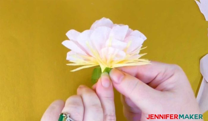 Gluing the stamen to the base of the crepe paper flower