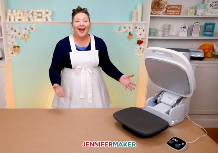 Jennifer with the Cricut Autopress heat press in the open position on her table