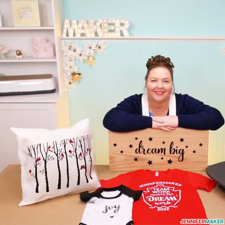 Jennifer Maker with projects made on the Cricut Autopress -- a wood sign, a pillow throw, a T-shirt, and a baby bodysuit