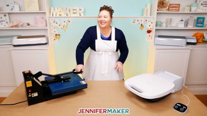 Jennifer pressing down the handle on a inexpensive clamshell heat press next to the Cricut Autopress