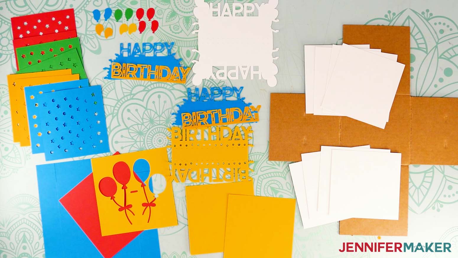 All the cut pieces for the happy birthday version of the cardboard jumping box displayed on a work surface