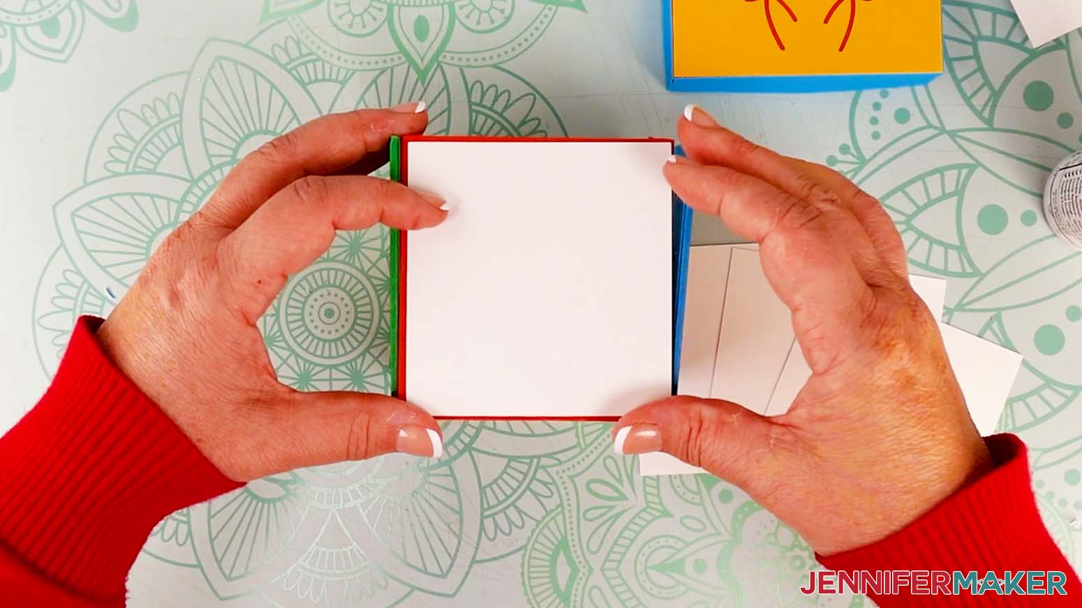 Glue the plain white square onto the cardboard jumping box side panel, making sure to face it the correct direction