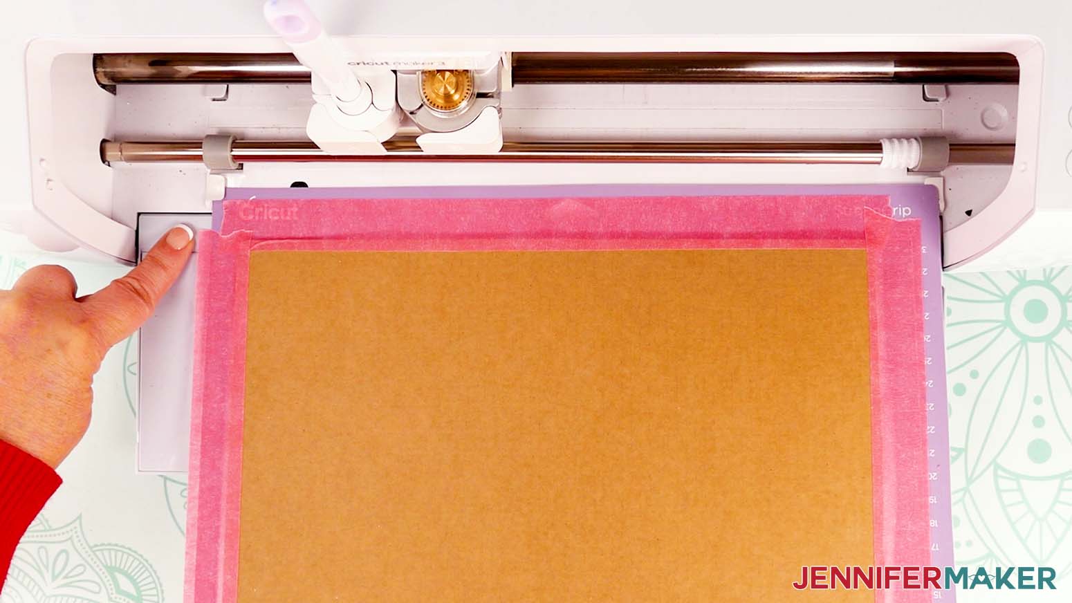 Remove any excess painter's tape that extends past the left side of the machine mat before cutting your cardboard jumping box base piece