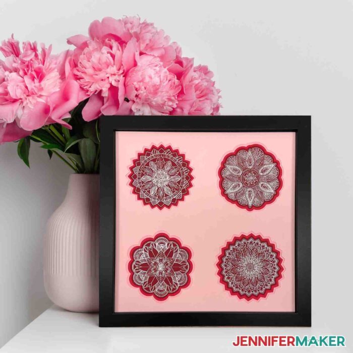 Framed foil home decor project next to a pink vase with pink flowers