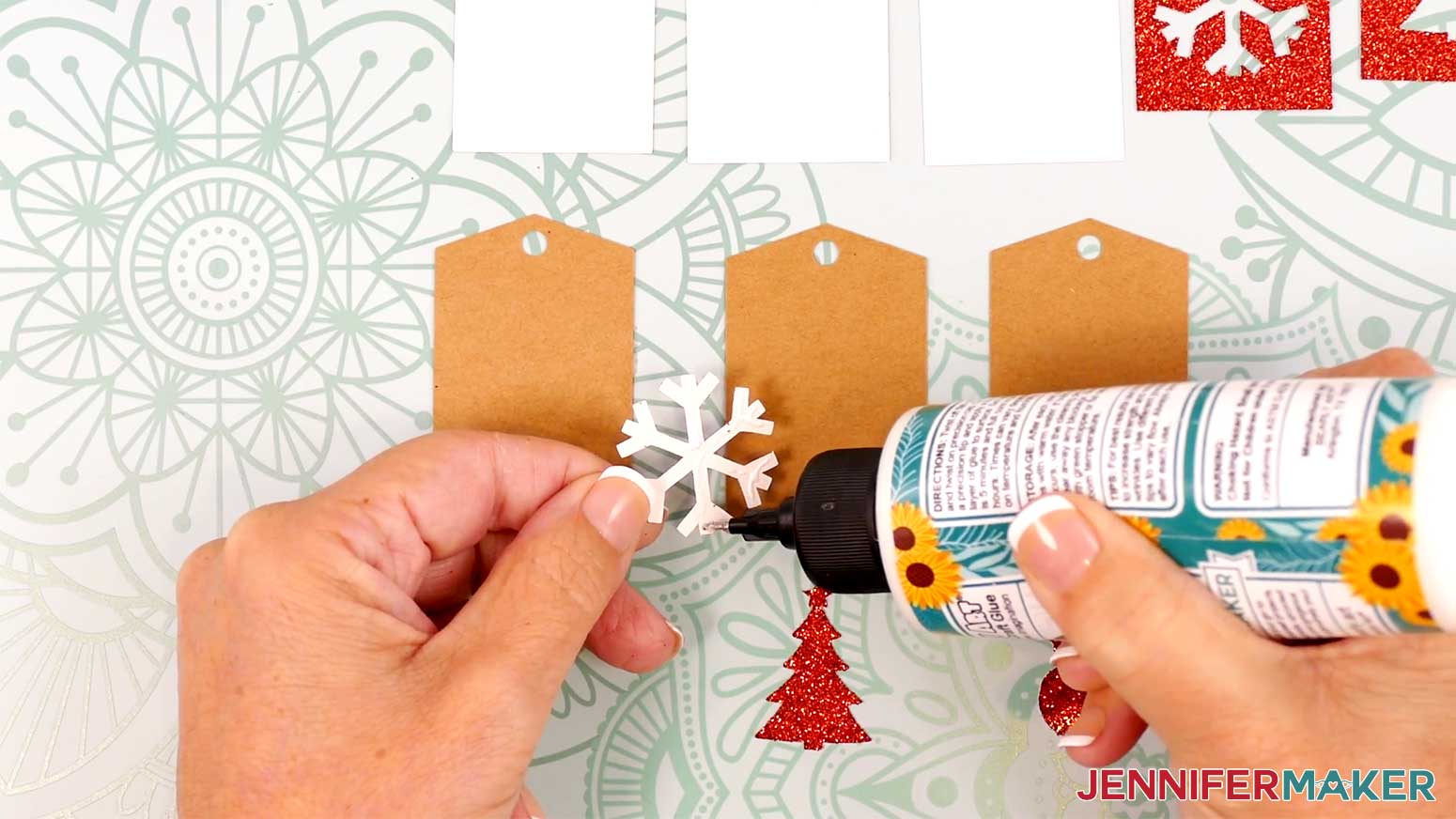 Add glue to the back of the small glitter pieces before adhering them to the kraft tags in the Cricut Gift Wrapping Ideas project.