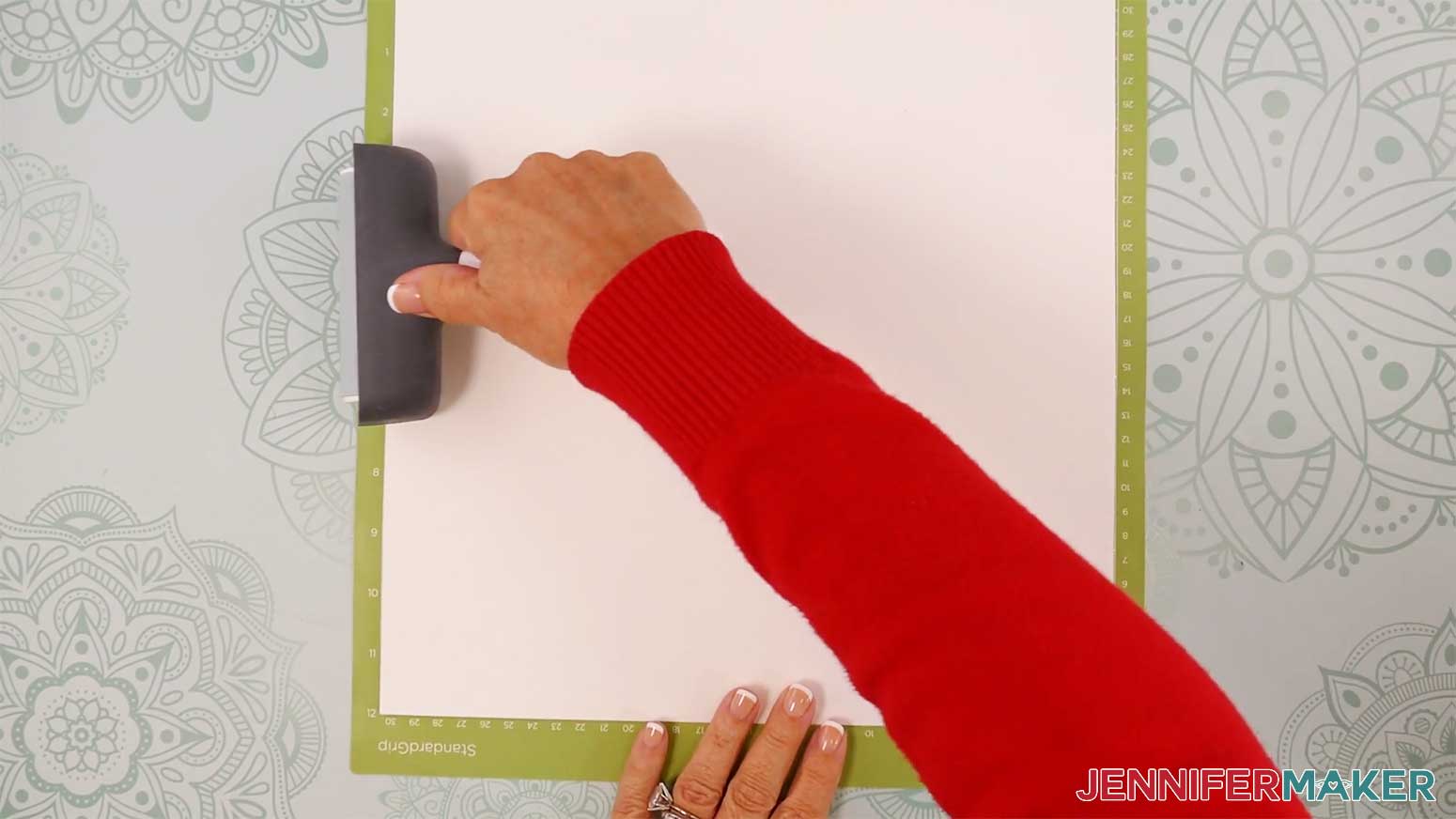 Use a brayer to fully adhere your cardstock to the machine mat in the Cricut Gift Wrapping Ideas project.