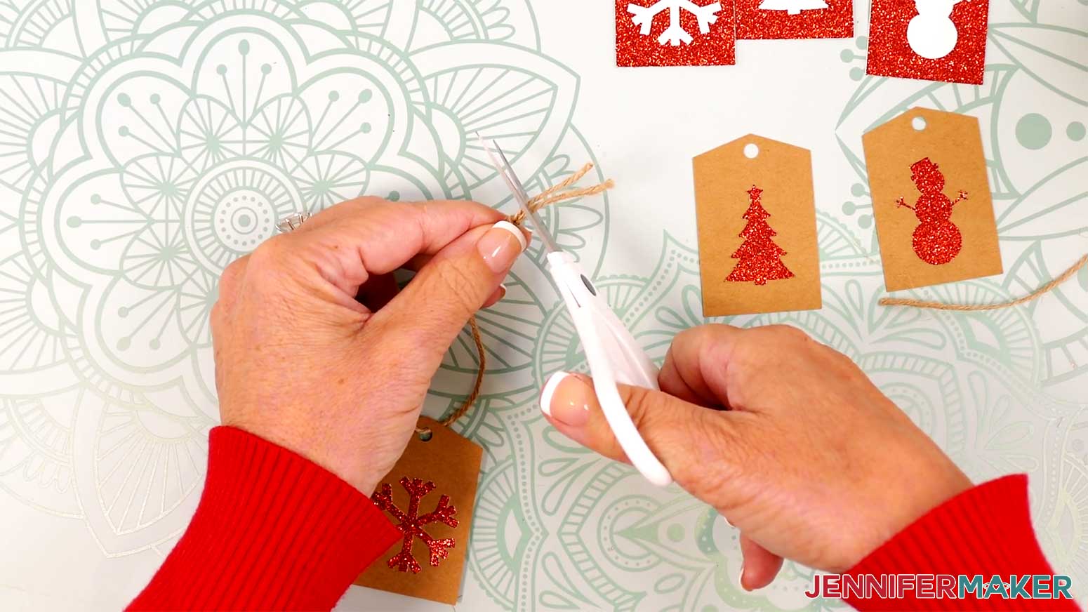 Add a piece of twine to each cutout gift tag in the Cricut Gift Wrapping Ideas project.