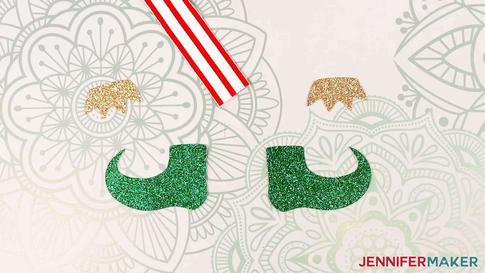 Cut pieces for the Elf Boots Ribbon, plus some ribbon, on the work surface in the Cricut Gift Wrapping Ideas project.