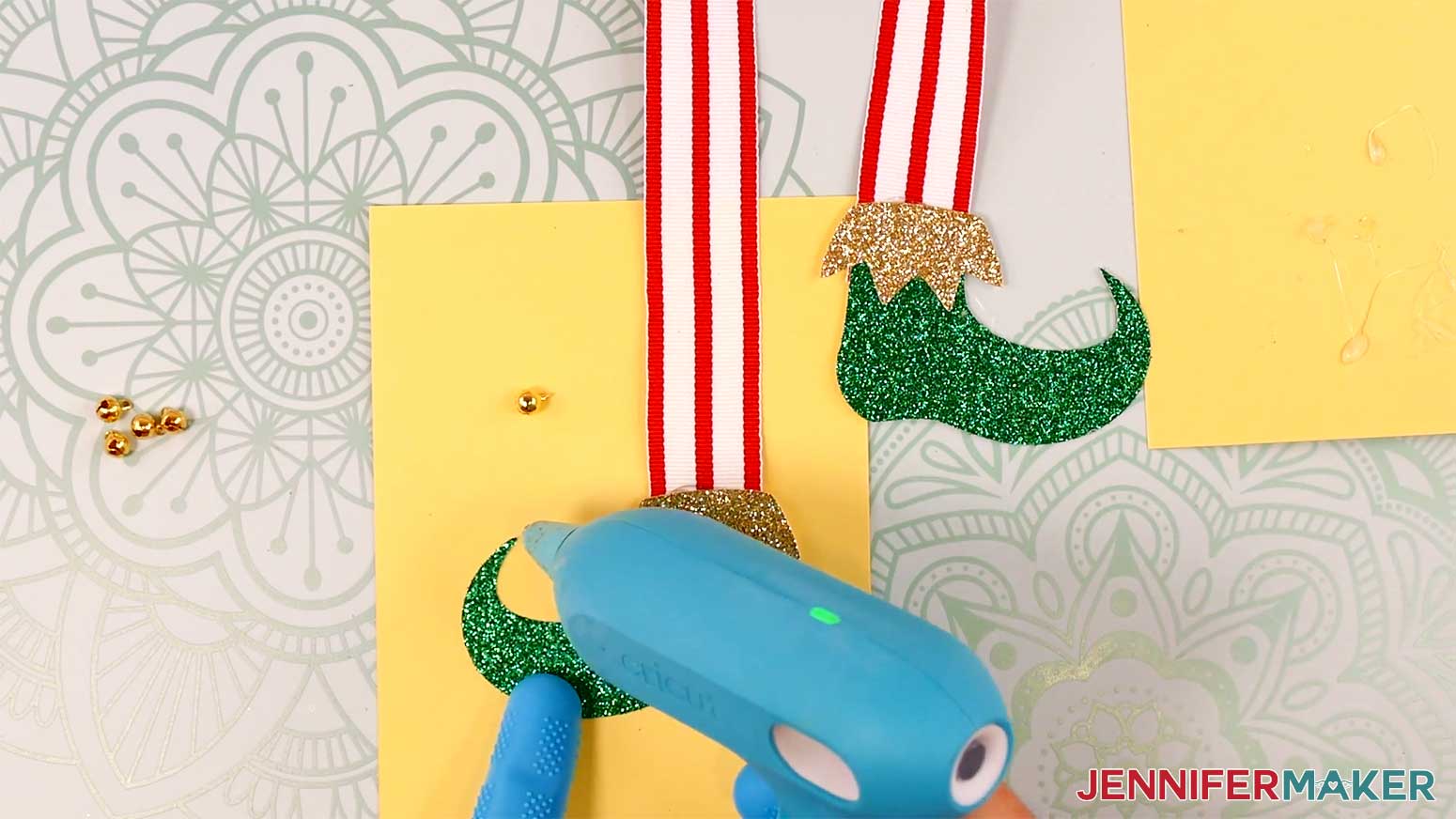 Apply hot glue to the tip of the elf boots in the Cricut Gift Wrapping Ideas project.