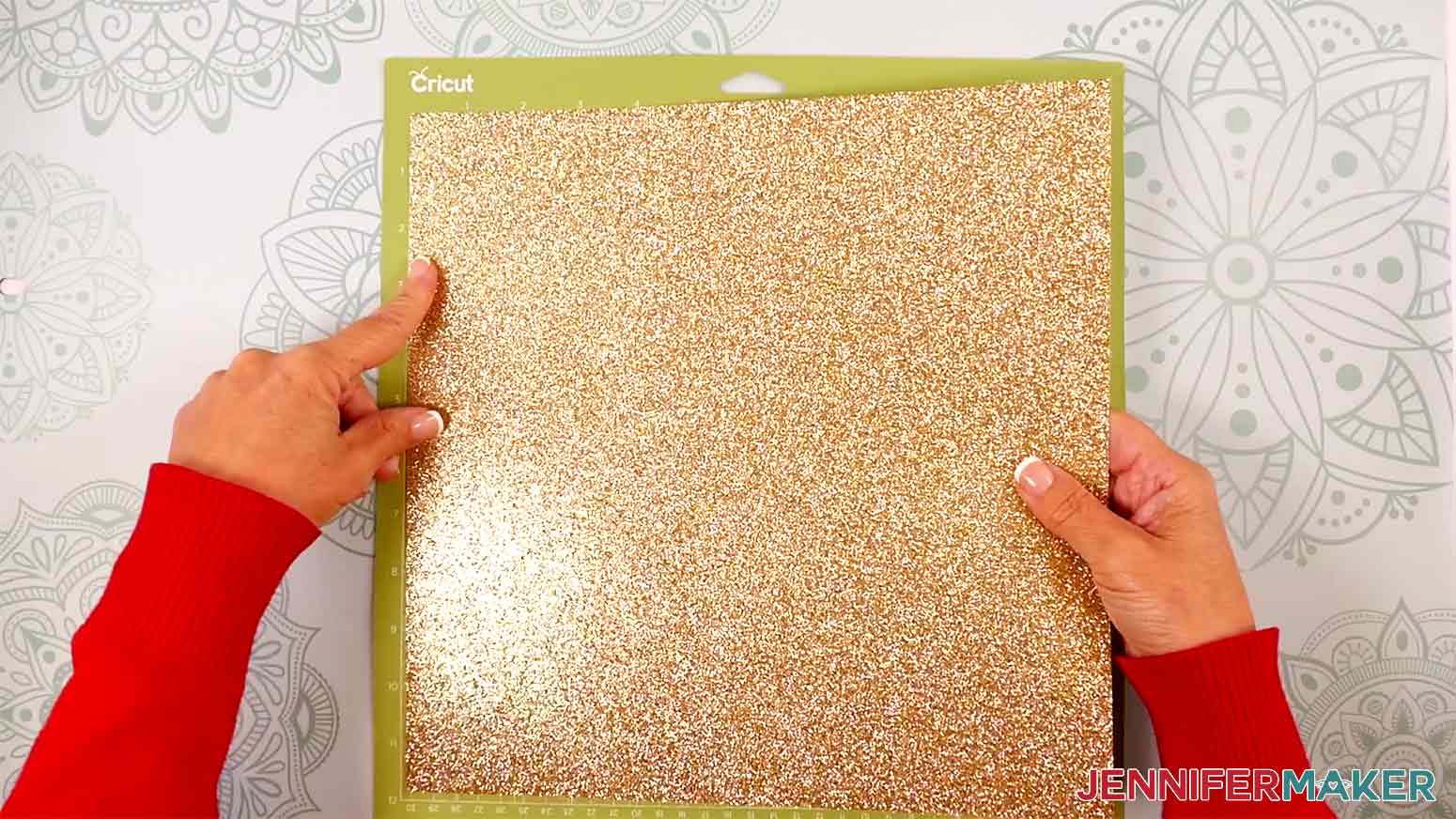 Adhere glitter cardstock for the Elf Boots Ribbon glitter-side up on a green StandardGrip machine mat in the Cricut Gift Wrapping Ideas project.