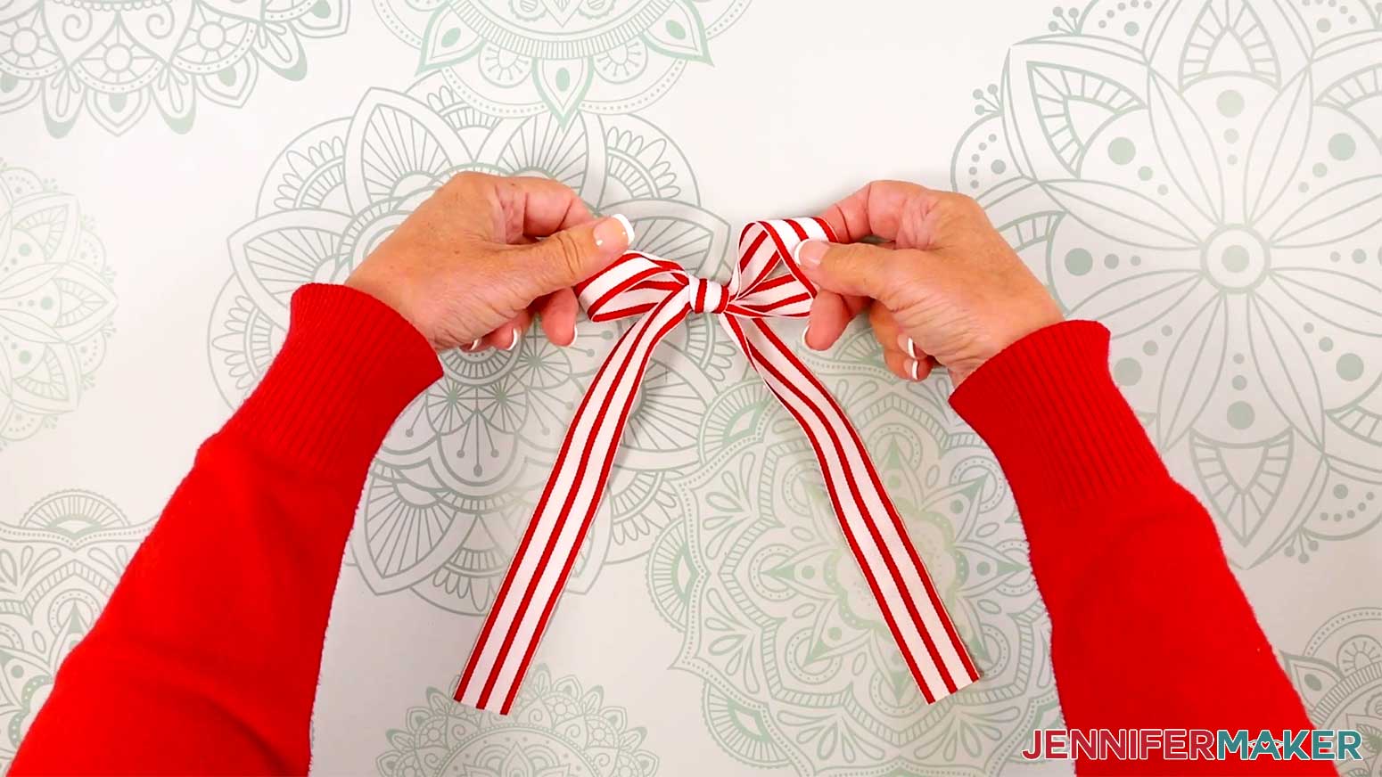 Tie a ribbon in a bow with long tails for the Elf Boots Ribbon in the Cricut Gift Wrapping Ideas project.