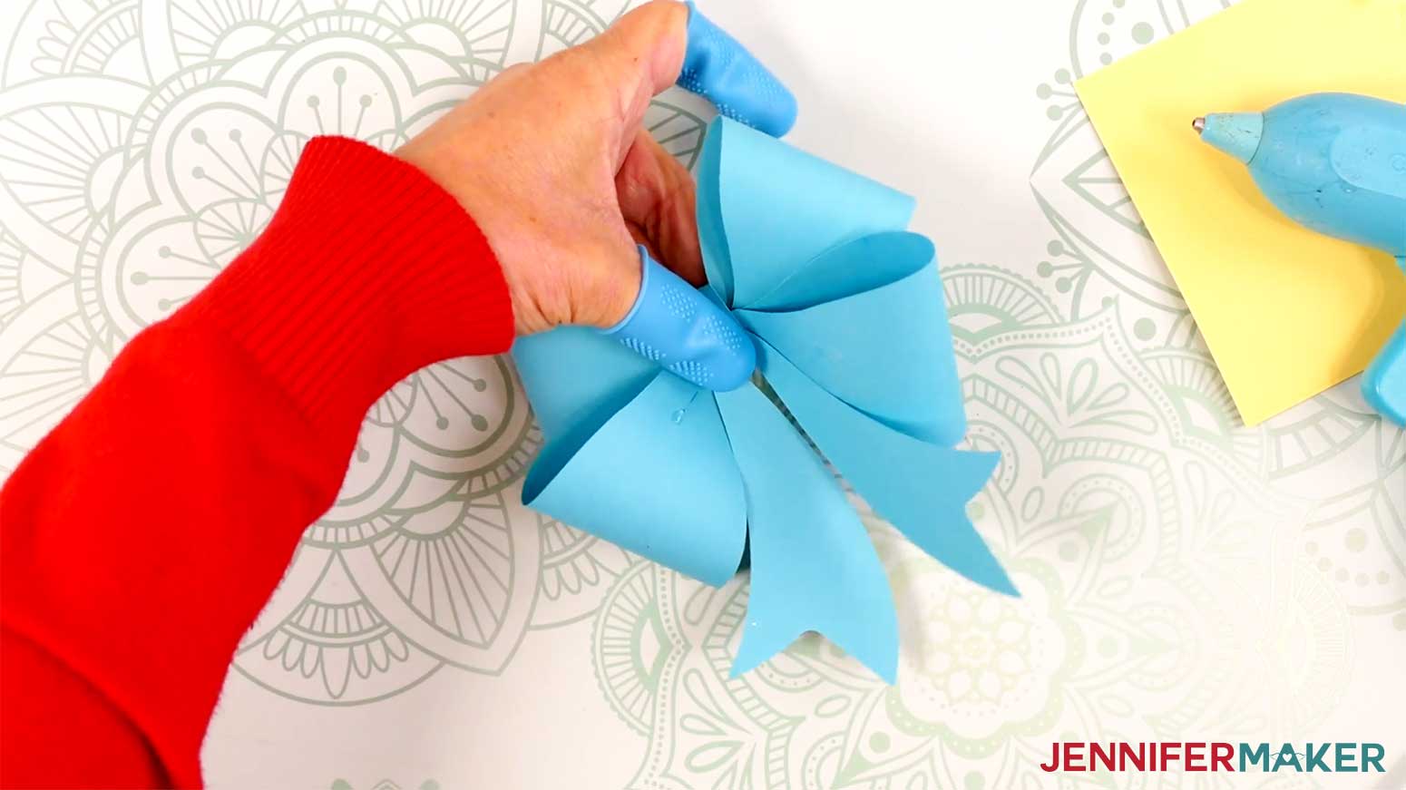 Adhere the tails piece to the center of the Fancy Paper Bow in the Cricut Gift Wrapping Ideas project.