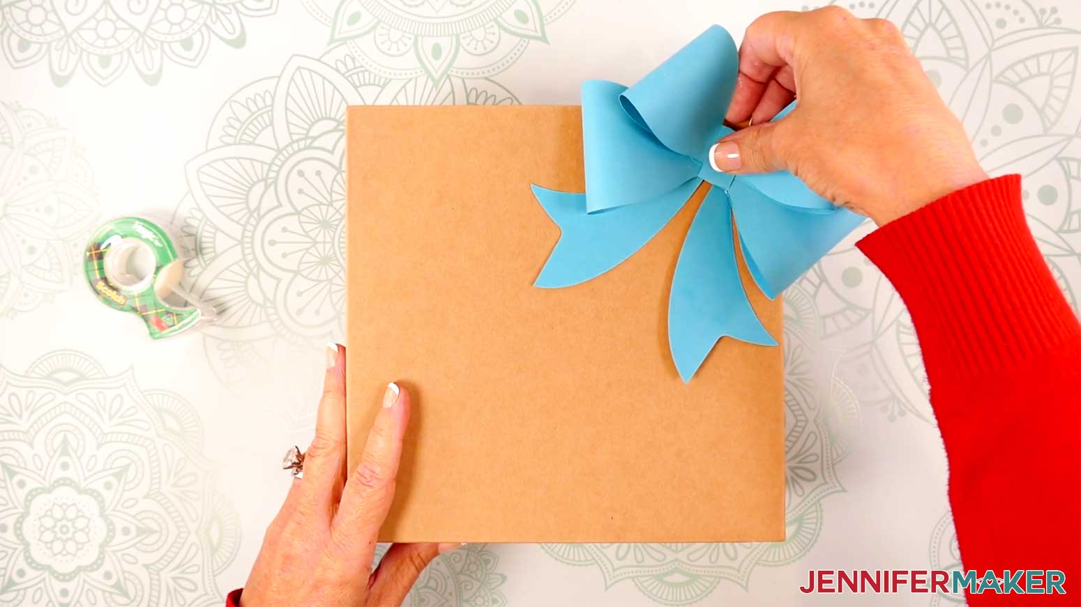 Adhere the taped Fancy Paper Bow to a wrapped gift in the Cricut Gift Wrapping Ideas project.