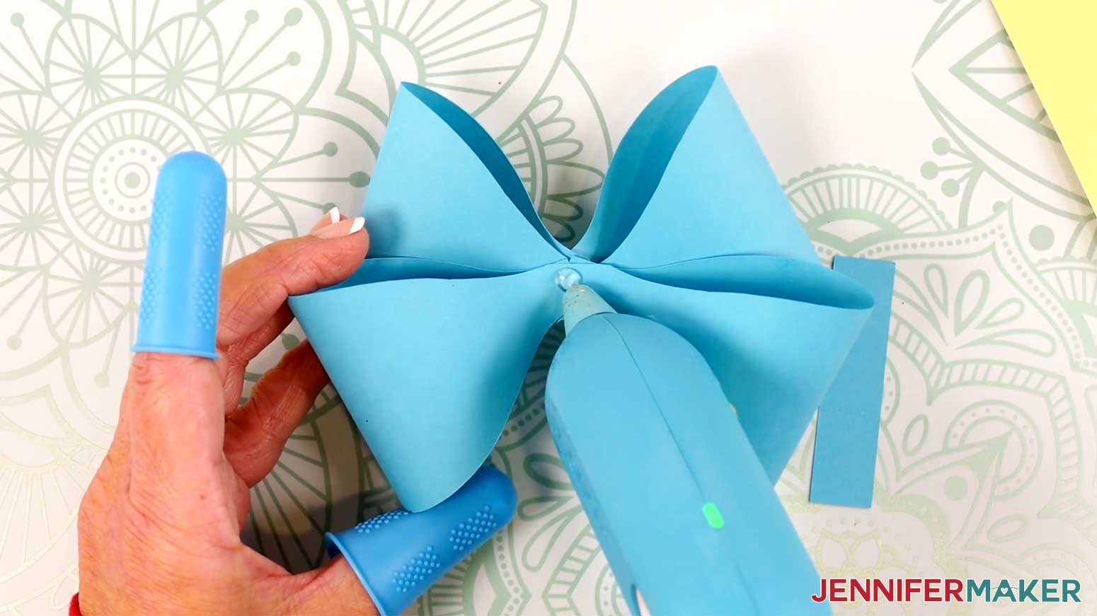 Apply hot glue to the center of the assembled loop pieces in the Cricut Gift Wrapping Ideas project.