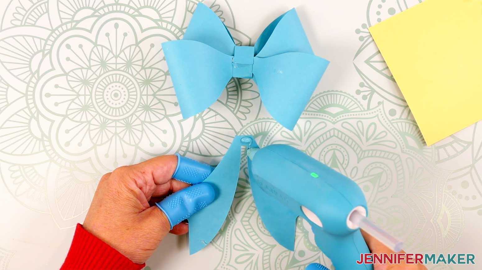 Apply hot glue to the top of the tails piece in the Cricut Gift Wrapping Ideas project.