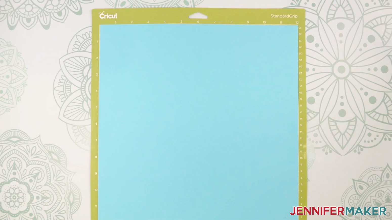 Adhere your cardstock to a green StandardGrip machine mat for the Fancy Paper Bow in the Cricut Gift Wrapping Ideas project.