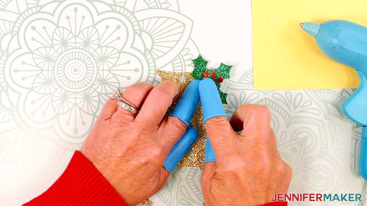 Adhere the holly piece to the letter so it partially hangs off the edges. Be sure not to obstruct the hole.