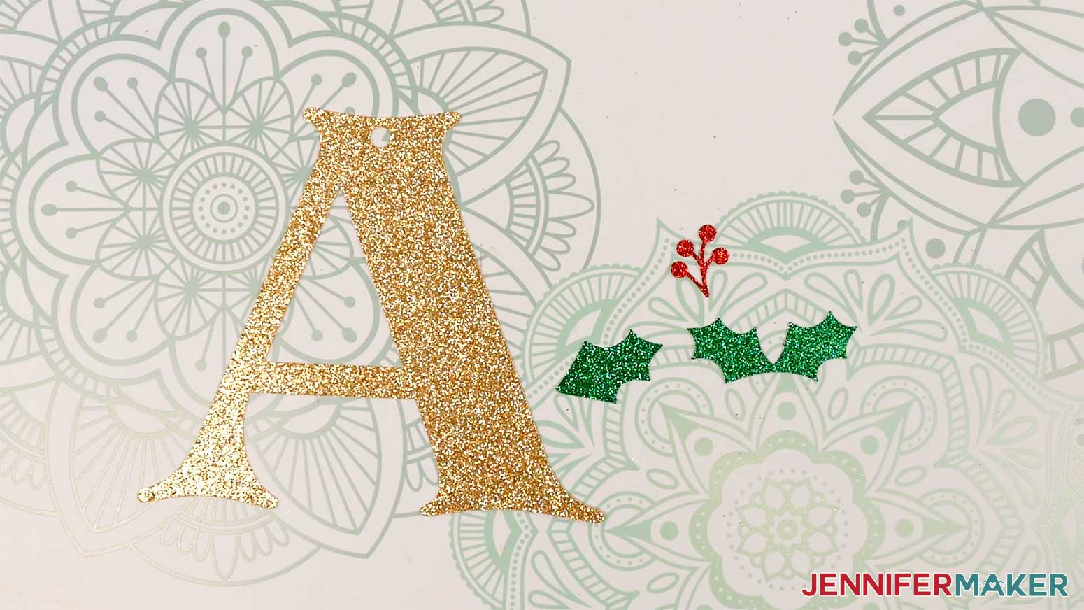 The holly letter gift tag pieces are cut from glitter cardstock: a gold letter A, three green holly leaves, and red berries.