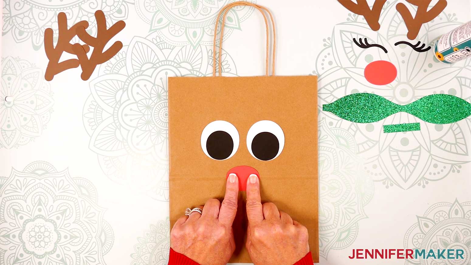Adhere the Reindeer Gift Bags' nose over the crease on the bag in the Cricut Gift Wrapping Ideas project.
