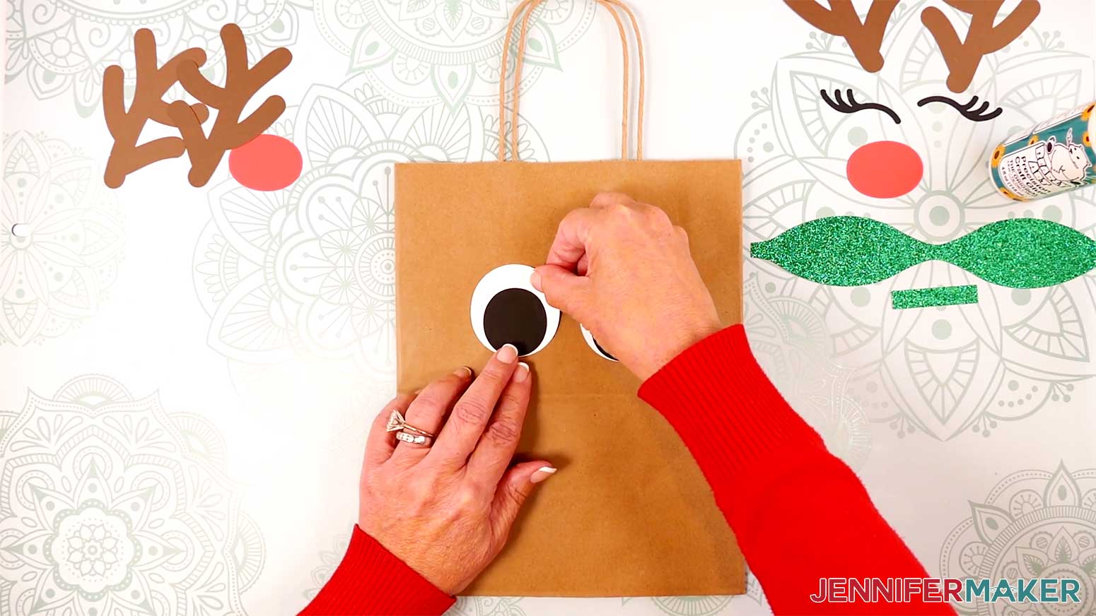 Adhere the Reindeer Gift Bags' assembled eyes above the crease on the bag in the Cricut Gift Wrapping Ideas project.