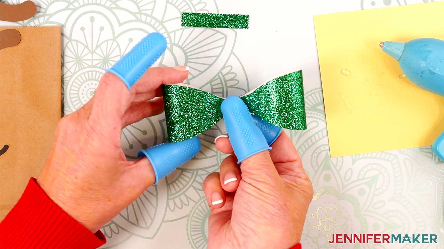 Fold in the second side of the Reindeer Gift Bags' bow in the Cricut Gift Wrapping Ideas project.