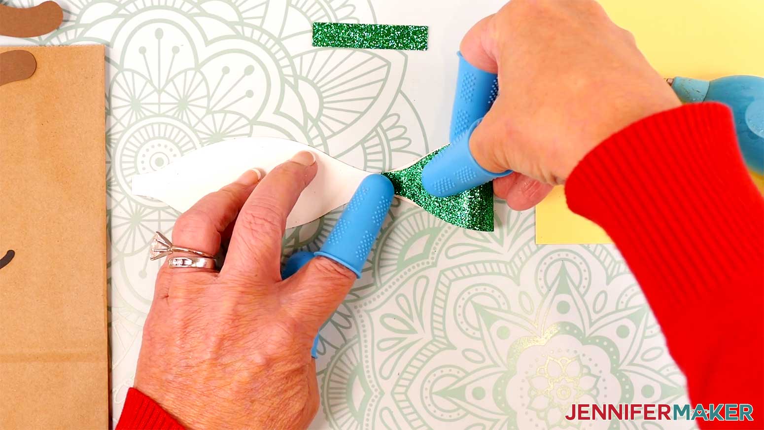 Fold in one side of the Reindeer Gift Bags' bow in the Cricut Gift Wrapping Ideas project.