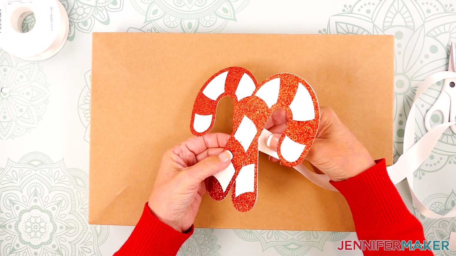 Slide the ribbon from the back of the slider through one slit, then down through the other slit.