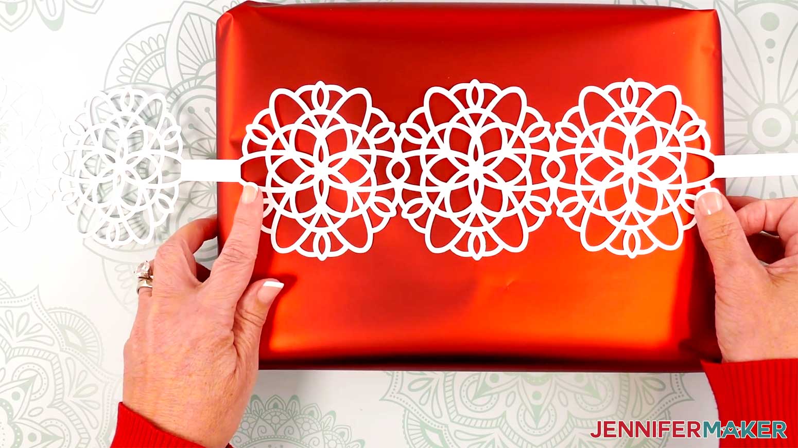 Center the set of three snowflakes on the box you want to decorate.