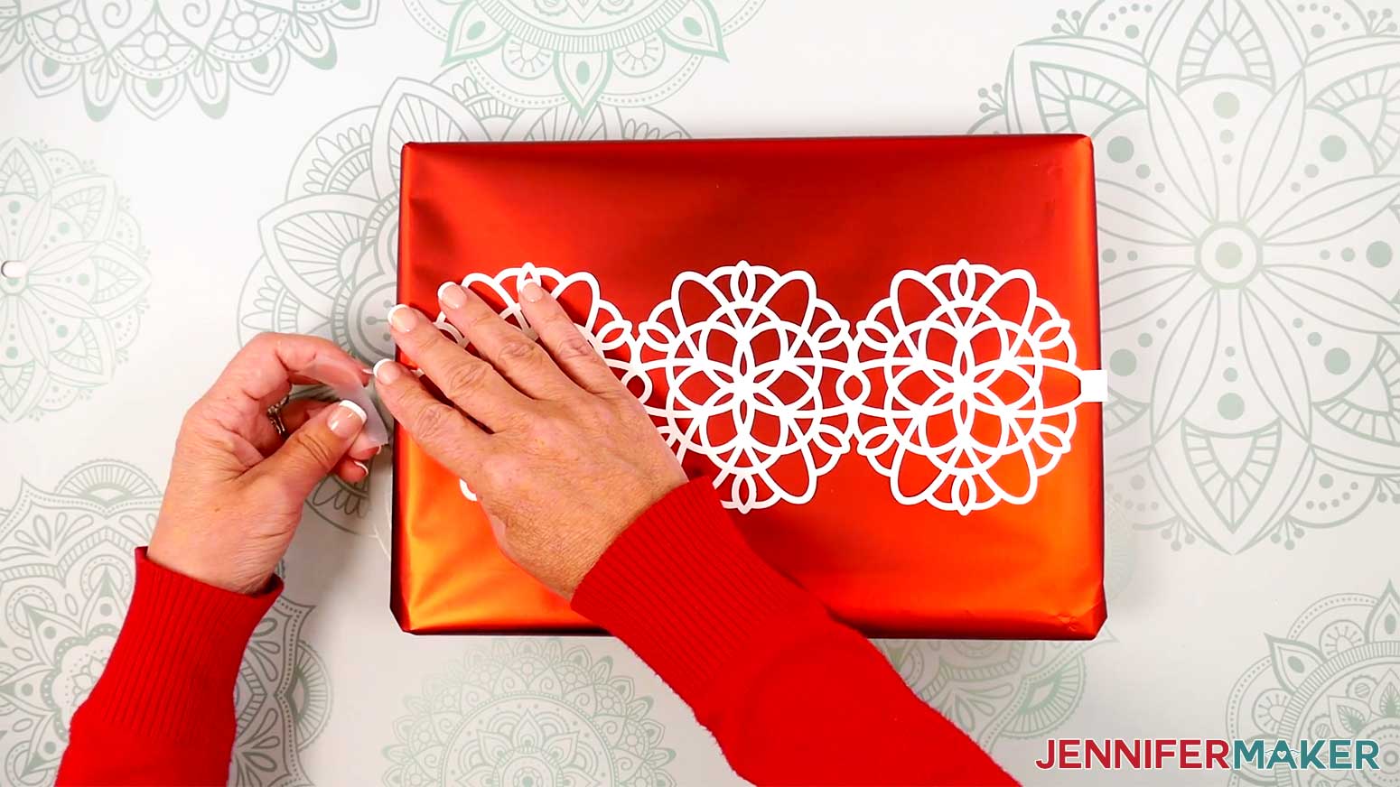 Secure the loose end of the snowflake wrap to the box with tape.