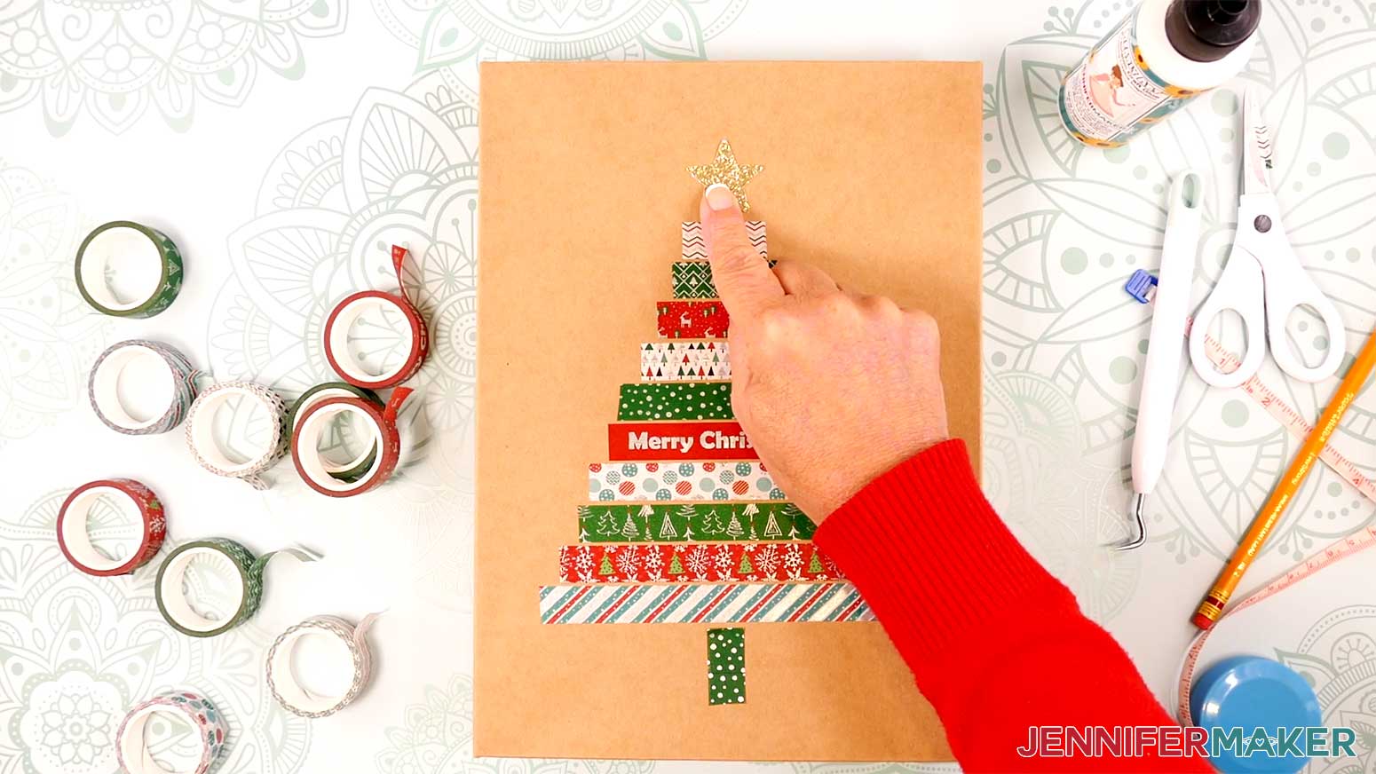 Use craft glue to adhere the star to the top of the washi tape tree in the Cricut Gift Wrapping Ideas project.