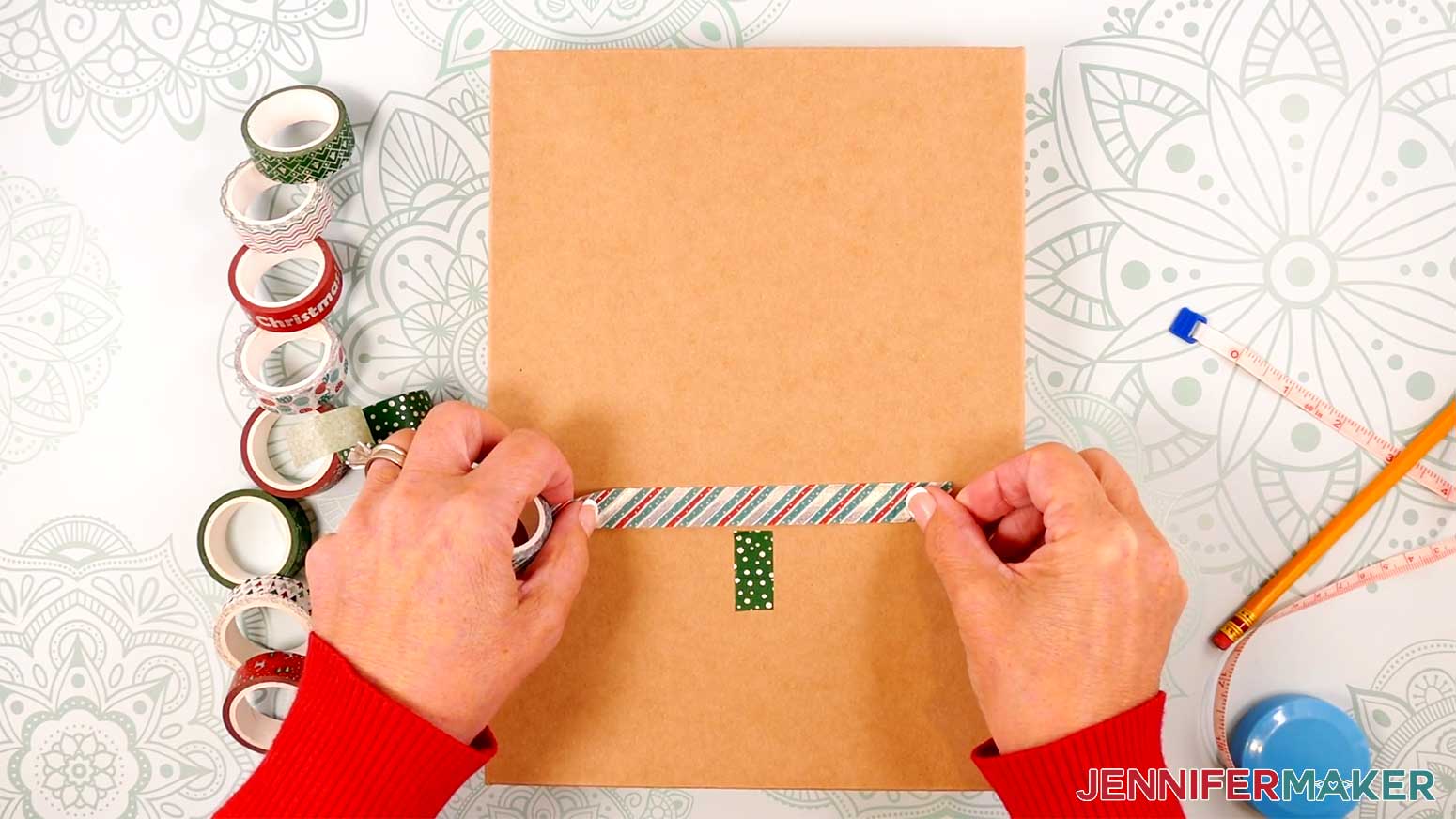Adhere a longer piece of different-patterned washi tape perpendicularly to the 1-inch long piece for the Washi Tape decoration in the Cricut Gift Wrapping Ideas project.