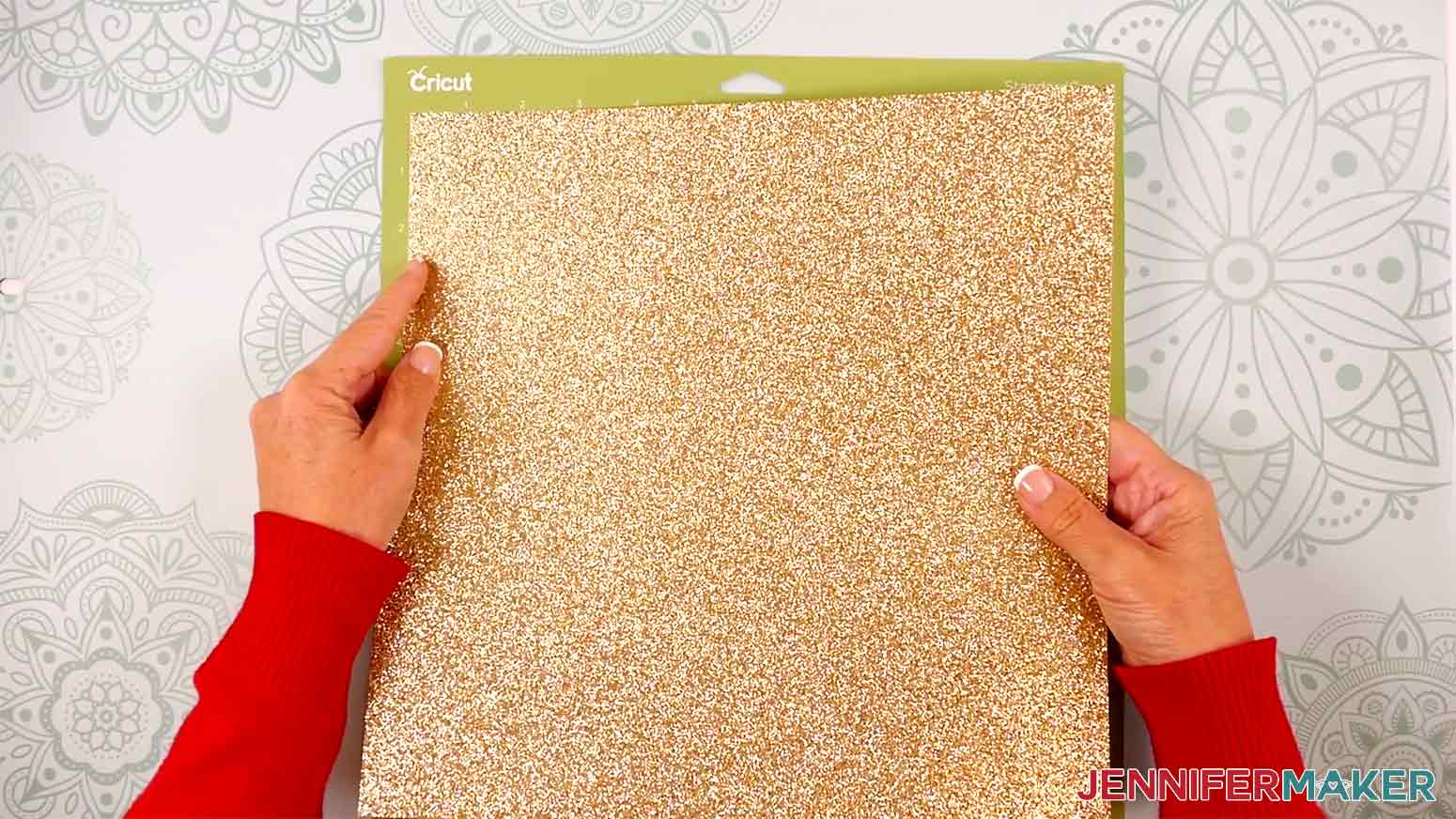 Adhere glitter cardstock glitter-side up to a green StandardGrip machine mat for the Washi Tape decoration in the Cricut Gift Wrapping Ideas project.