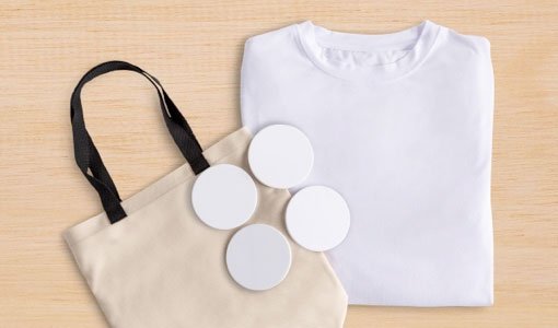 Totebag, round ceramic coasters, and white T-shirt are some of the Cricut Infusible Ink blanks available.