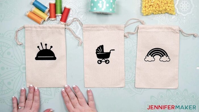 Cotton bags with icon Cricut labels using iron-on vinyl.