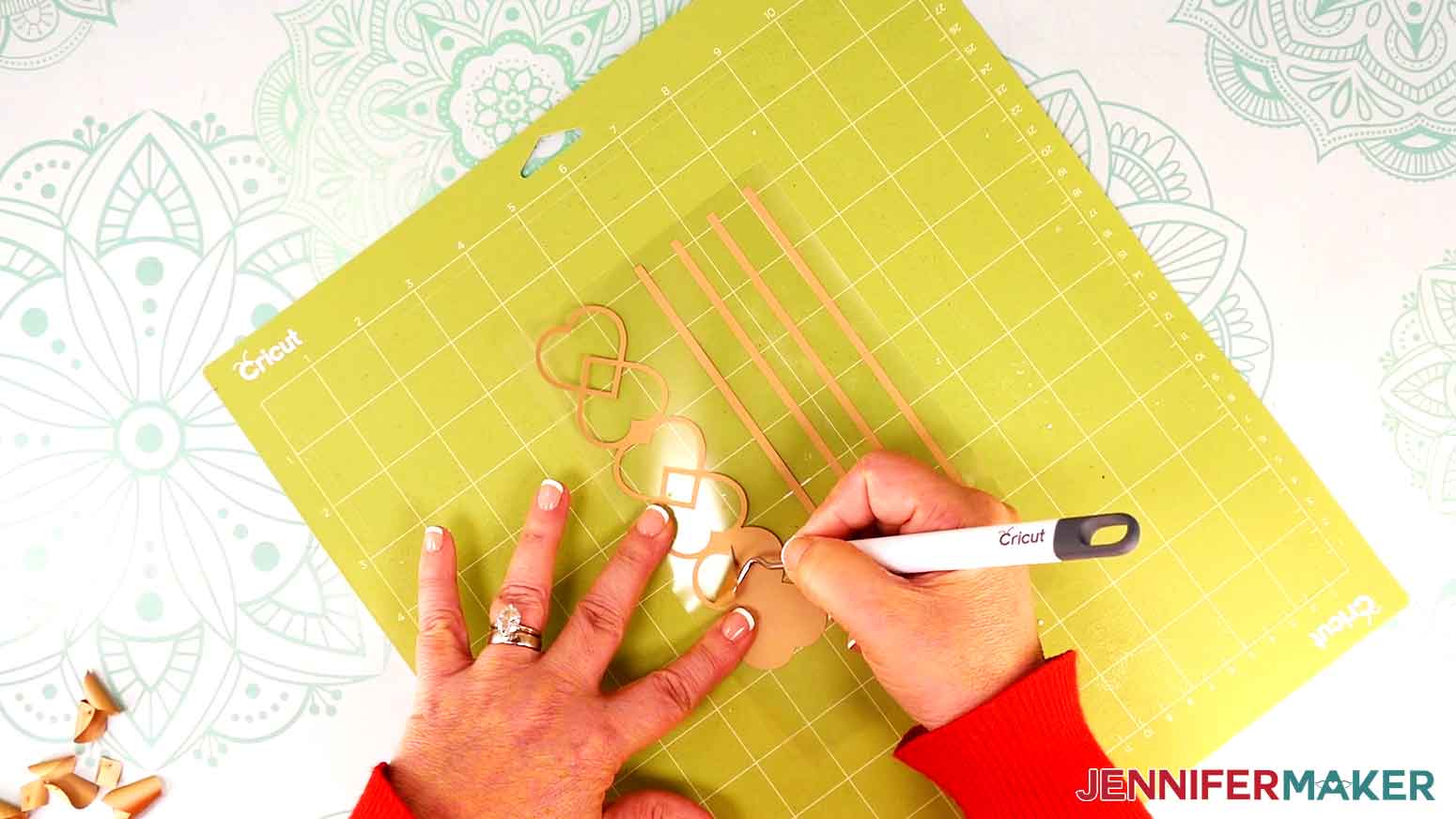 Use a weeding tool to remove excess iron-on vinyl.
