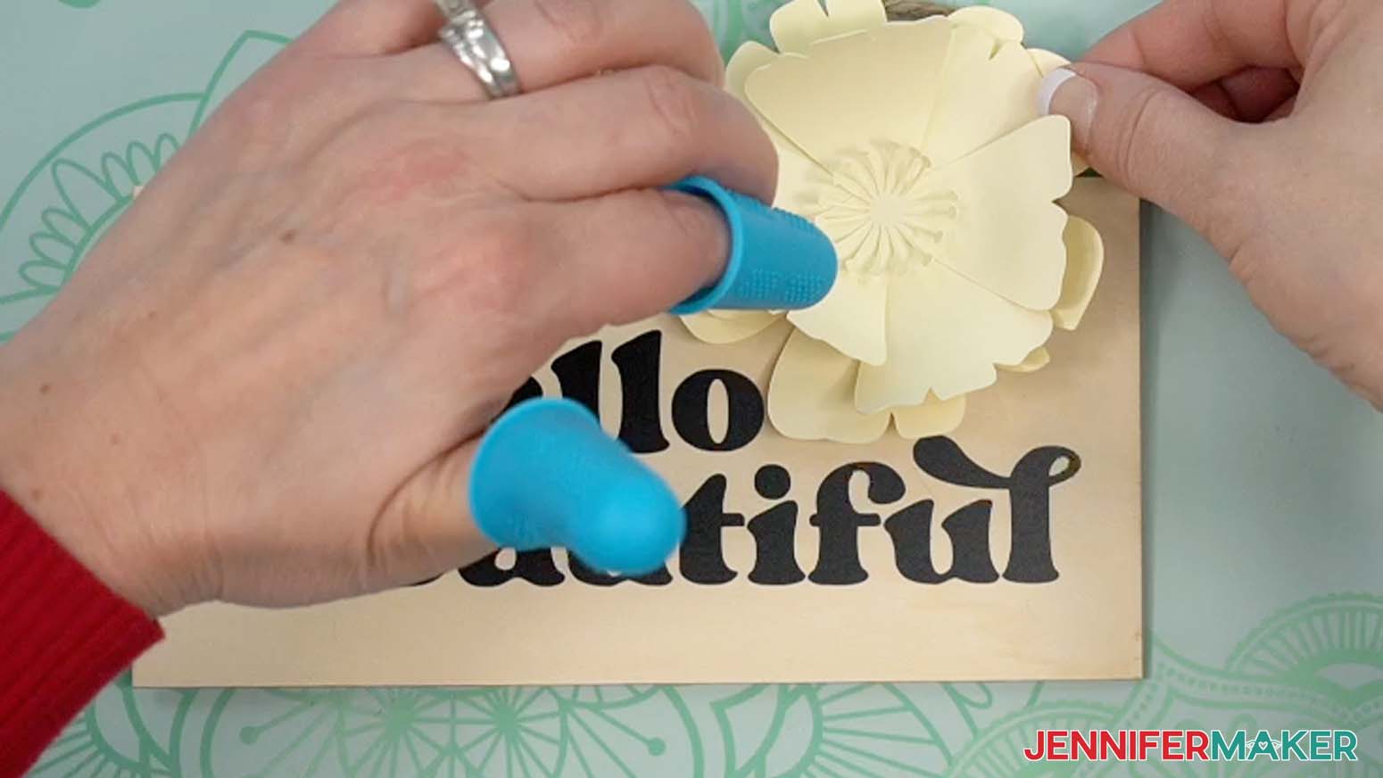 glue paper flower to sign.