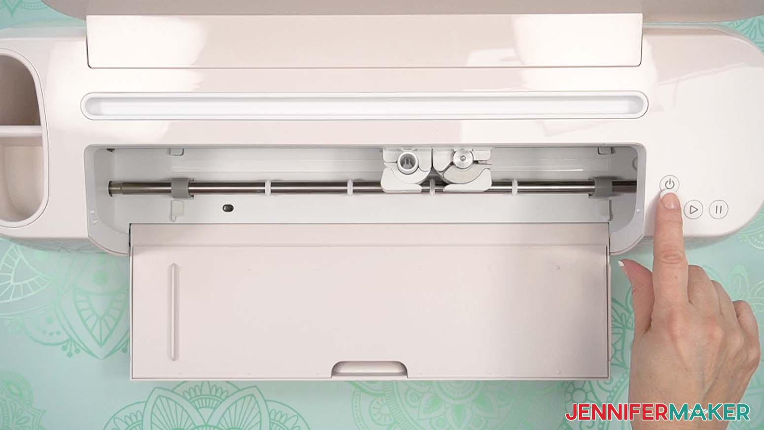 Press the power button on the top right of the Cricut Maker 4.
