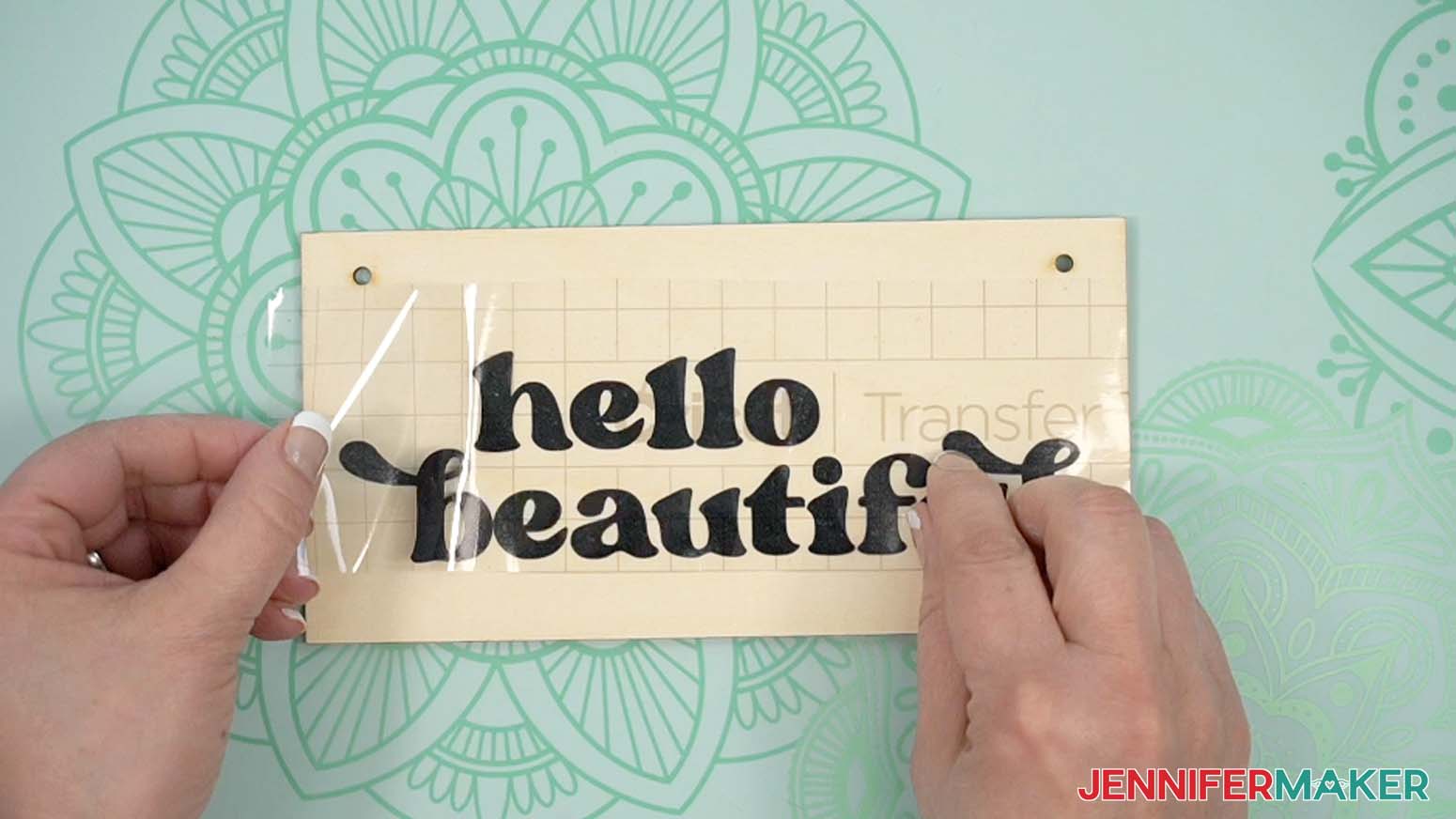 Apply the "hello beautiful" adhesive vinyl design to the wooden sign using Cricut transfer tape.