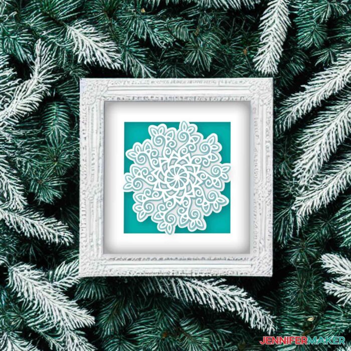 Green and white vine paper mandala in a white frame for the holidays