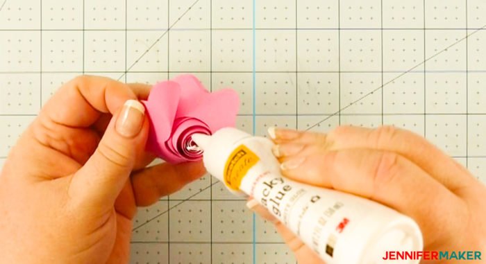 Gluing the rolled ends of a Cricut paper flower