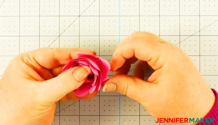 Arrange the petals on the Cricut paper flower as the glue dries