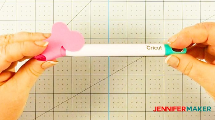 Rolling a cut-out paper pattern around the Cricut quilling tool to make a Cricut paper flower