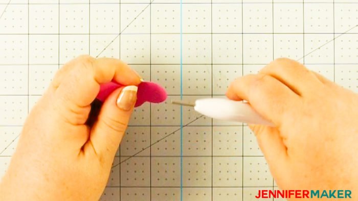 Removing the Cricut quilling tool from the rolled paper flower